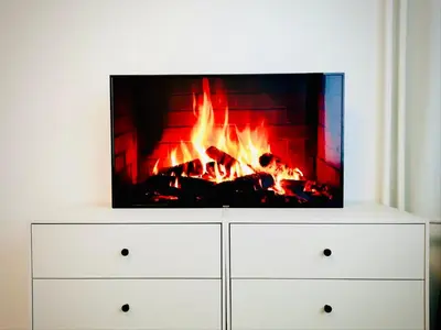 a tv sitting on top of a dresser with a fireplace at M&M Apartment VII Self CHECK-IN in Panevėžys