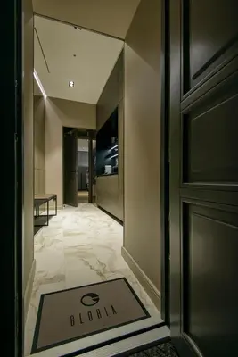 a hallway with a door and a sign on the floor at Luxury Smart Home Apartment in Vilnius Old Town, Sleep on Hästens in Vilnius