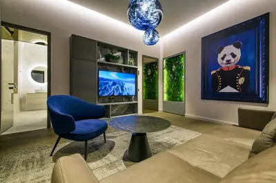a living room with a panda bear painting on the wall at Luxury Smart Home Apartment in Vilnius Old Town, Sleep on Hästens in Vilnius