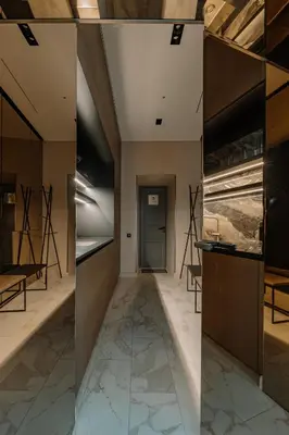 a hallway with marble flooring and a glass wall at Luxury Smart Home Apartment in Vilnius Old Town, Sleep on Hästens in Vilnius