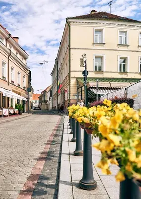 a street with a row of poles with flowers at Luxury Smart Home Apartment in Vilnius Old Town, Sleep on Hästens in Vilnius