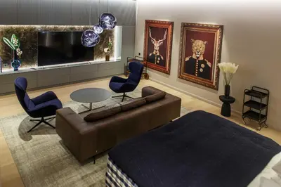 a living room with a couch and chairs and a tv at Luxury Smart Home Apartment in Vilnius Old Town, Sleep on Hästens in Vilnius