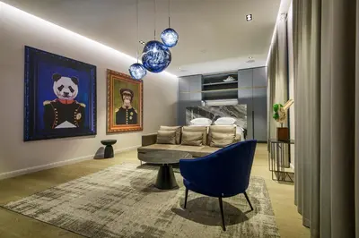 a living room with a couch and a chair at Luxury Smart Home Apartment in Vilnius Old Town, Sleep on Hästens in Vilnius