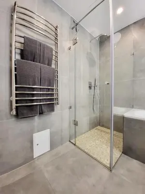 a bathroom with a shower with a glass door at E.D. Luxury Apartaments in Šiauliai