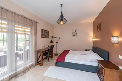 a bedroom with a bed and a desk and a window at Calm and private apartment by Polo Apartments in Kaunas