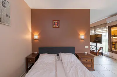 a bedroom with a bed and a tv on a wall at Calm and private apartment by Polo Apartments in Kaunas