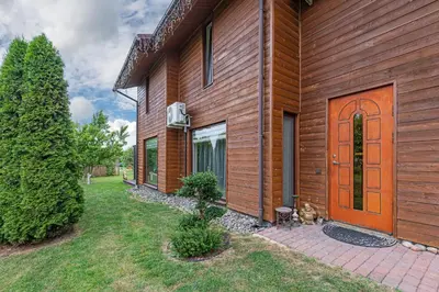 a wooden house with a door and a yard at Calm and private apartment by Polo Apartments in Kaunas