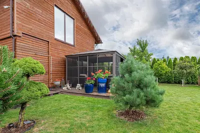 a house with a greenhouse in a yard at Calm and private apartment by Polo Apartments in Kaunas