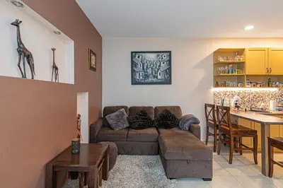 a living room with a couch and a table at Calm and private apartment by Polo Apartments in Kaunas