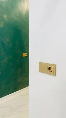 a white refrigerator in a room with a green wall at Green & White Apartament in Anykščiai
