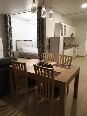 a kitchen and dining room with a table and chairs at Skuodo 2E in Kaunas