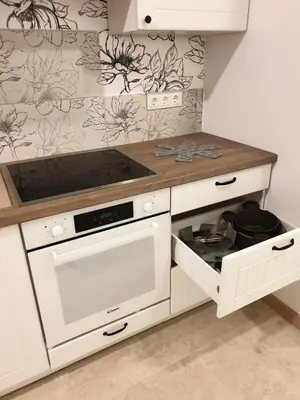 a kitchen with white cabinets and a stove top oven at Skuodo 2E in Kaunas