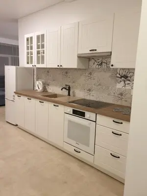 a kitchen with white cabinets and a sink at Skuodo 2E in Kaunas