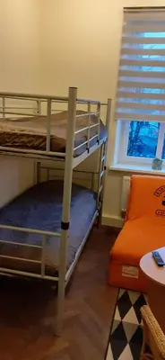 two bunk beds in a room with a window at Small room with a private external bathroom in Kaunas
