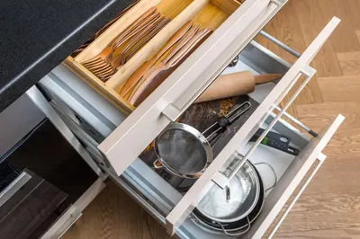 an open drawer in a kitchen with utensils at Old Town apartment l Self check in in Vilnius