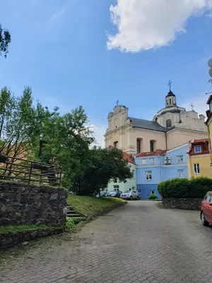 a cobblestone street in front of a large building at Old Town apartment l Self check in in Vilnius