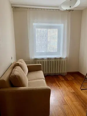 a living room with a couch and a window at Comfortable Stay in Siauliai in Šiauliai