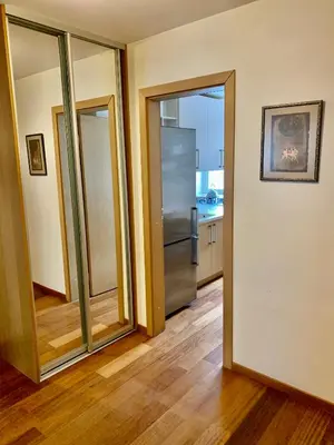 a kitchen with a stainless steel refrigerator and sliding glass doors at Comfortable Stay in Siauliai in Šiauliai
