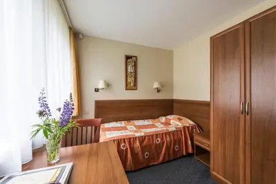a hotel room with a bed and a table at ORO Dubingiai in Giraičiai