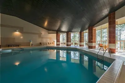 a large swimming pool with blue water in a building at ORO Dubingiai in Giraičiai