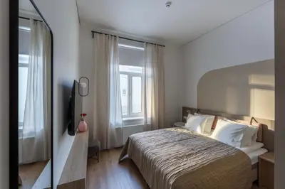 a bedroom with a large bed and a window at Laisves ave. Apartments Mini in Kaunas