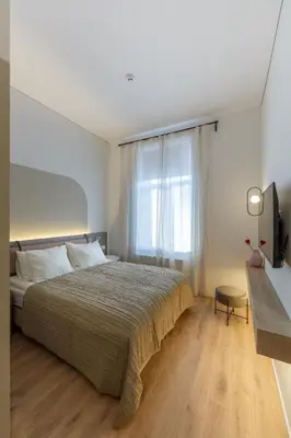 a bedroom with a large bed and a window at Laisves ave. Apartments Mini in Kaunas