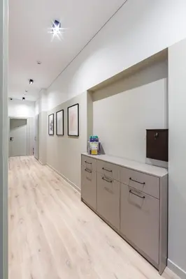 a large room with white walls and a wooden floor at Laisves ave. Apartments Mini in Kaunas