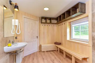 a bathroom with a sink and a window at Namelis ant vandens 