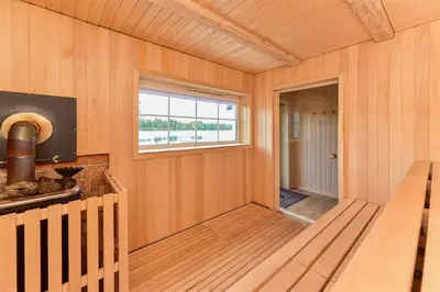 an empty room with a window and a staircase at Namelis ant vandens 