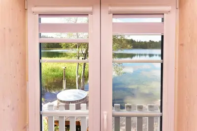 a window with a view of a lake at Namelis ant vandens 