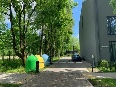 a building with two tents parked next to a street at Botanical Manor Apartment in Kaunas
