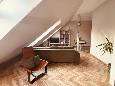 a living room with a couch and a chair at Botanical Manor Apartment in Kaunas
