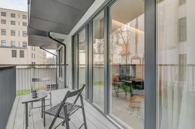 a patio with a table and chairs on a balcony at HaPPy Inn G, Self check-in, Terrace, Underground Parking in Vilnius