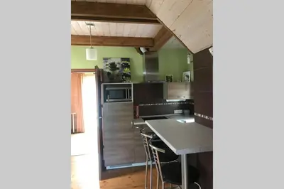 a kitchen with a refrigerator and a counter top at Rustic private Cabin in woods w/ Sauna & Pool in Vilnius