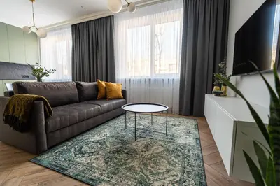 a living room with a couch and a table at Cozy Apartment In Kaunas Center in Kaunas