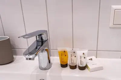a counter top with two cups on a sink at Cozy Apartment In Kaunas Center in Kaunas