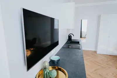 a living room with a large flat screen tv on a wall at Wonderful Apartment In The Heart Of Kaunas Center in Kaunas