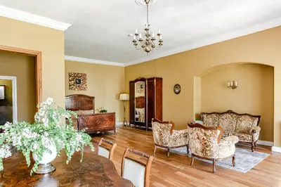 a living room with a table and chairs at Taujėnų dvaro svečių namai in Towiany