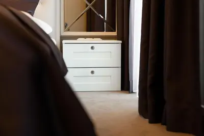 a white dresser with a mirror in a bedroom at Vilnius legends house I Best for families I Free parking in Vilnius