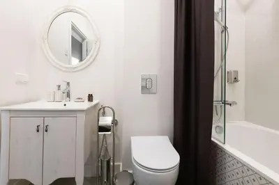 a bathroom with a toilet and a sink and a mirror at Vilnius legends house I Best for families I Free parking in Vilnius