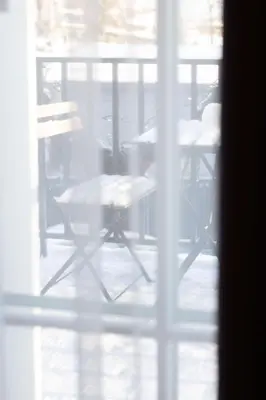 a table and chairs are seen through a window at Vilnius legends house I Best for families I Free parking in Vilnius