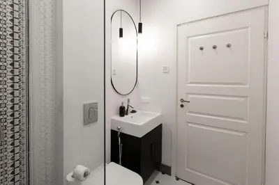 a bathroom with a sink and a toilet and a mirror at Vilnius legends house I Best for families I Free parking in Vilnius