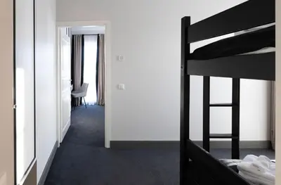 a bedroom with a bunk bed and a desk at Vilnius legends house I Best for families I Free parking in Vilnius