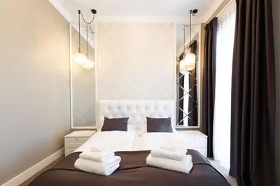 a bedroom with a bed with white towels on it at Vilnius legends house I Best for families I Free parking in Vilnius