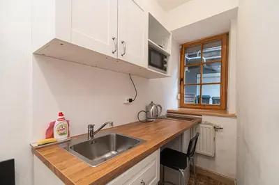 a small kitchen with a sink and a microwave at St Anne studio in Vilnius
