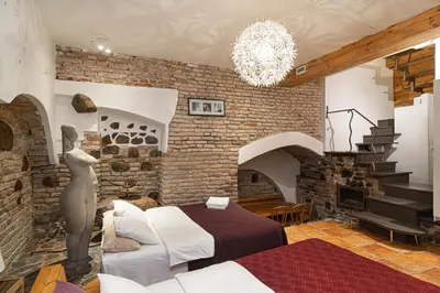 a bedroom with a bed and a brick wall at St Anne studio in Vilnius