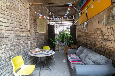 a patio with a couch and a table and chairs at St Anne studio in Vilnius