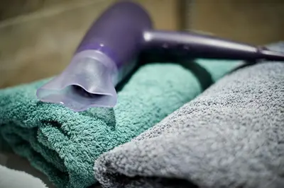 a purple brush sitting on top of a green towel at Old Town Apart FREE Parking in Vilnius