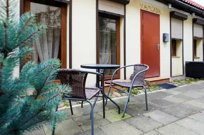 two chairs and a table in front of a building at Old Town Apart FREE Parking in Vilnius
