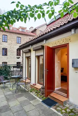 a building with a red door and a table at Old Town Apart FREE Parking in Vilnius